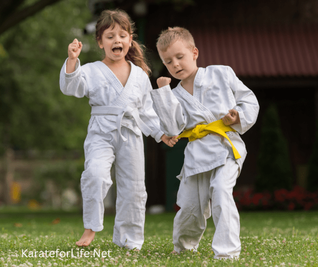 A boy and a girl around 6yrs practicing Karate in the garden.